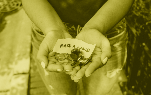 Photo of a persons hands holding money (coins) and a piece of paper that reads 'make a change'